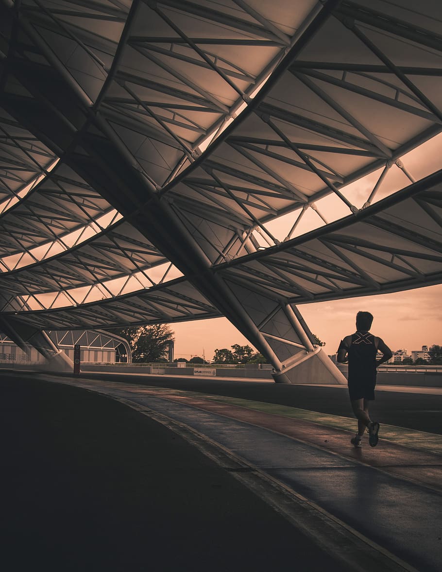 man wearing black shorts while running, man running inside building HD wallpaper