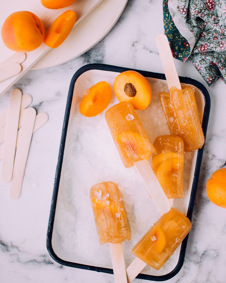 flat lay photography of ice cream popsicles, yellow popsicle ice cream in freezer HD wallpaper