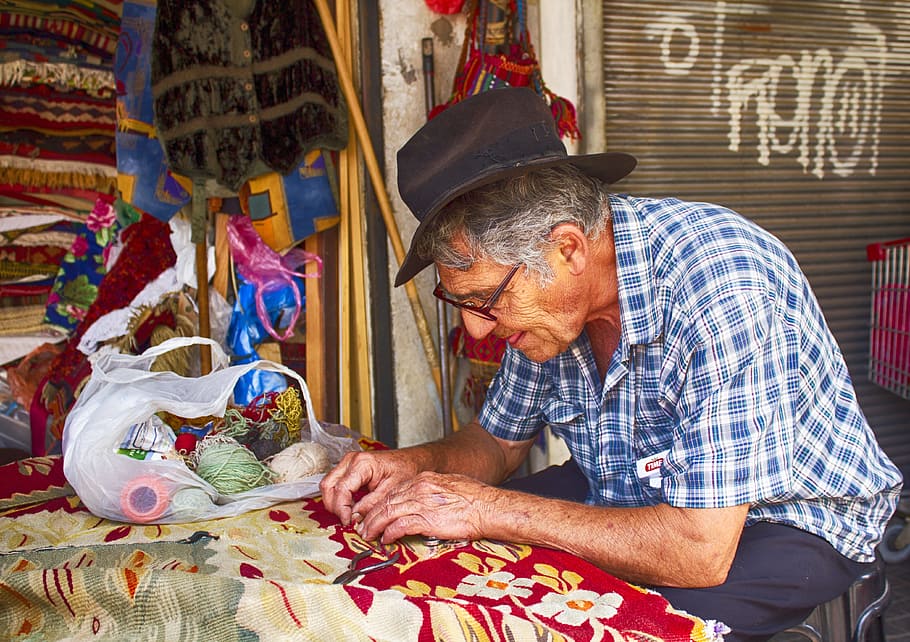 man making carpet while sitting on chair, men, working, tel aviv HD wallpaper