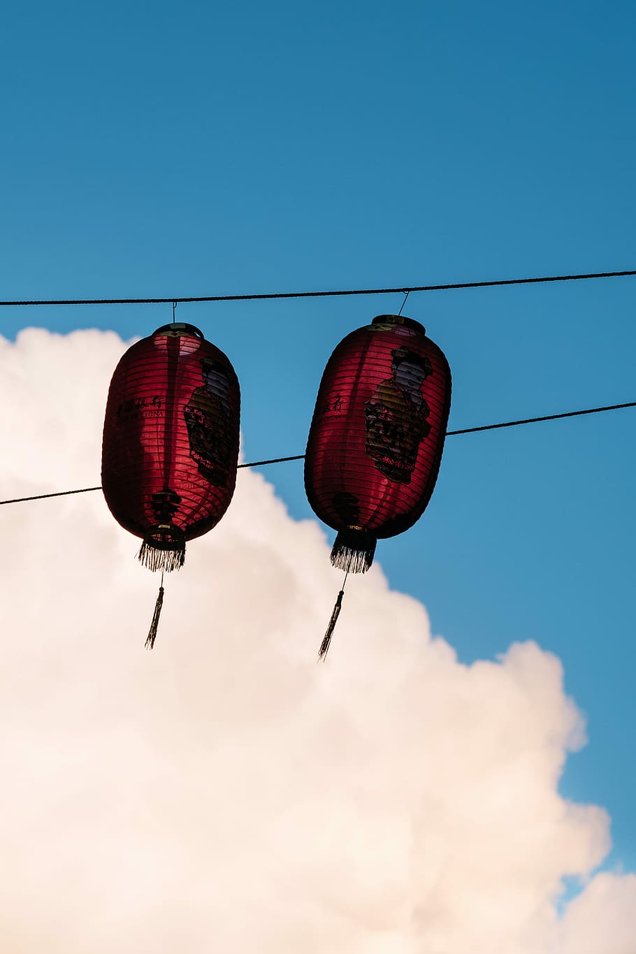 two red paper lanterns, two red paper lanterns hanging on black string during daytime HD wallpaper