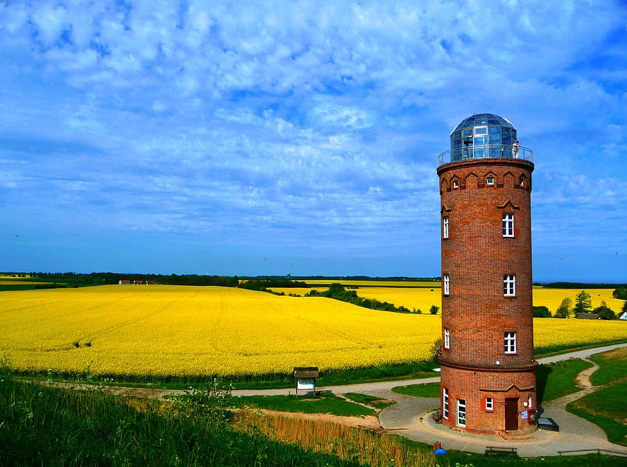 brown concrete tower near field under blue sky and white clouds during daytime HD wallpaper