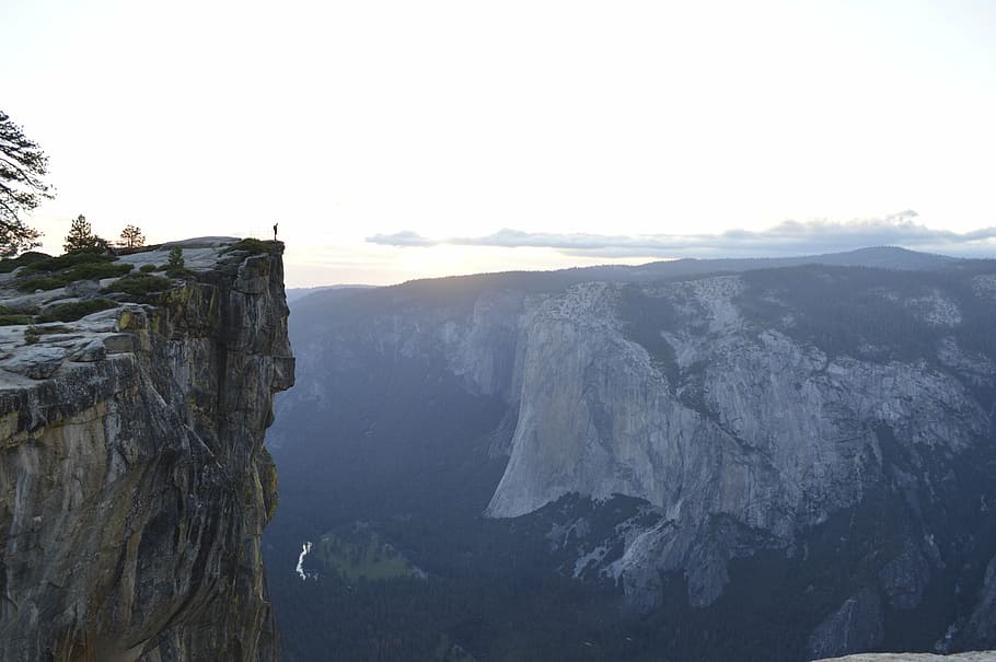person standing on cliff, rock, mountain, white, sky, nature HD wallpaper