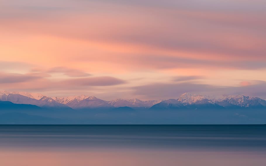 body of water with golden time, ocean near mountains under cloudy sky HD wallpaper