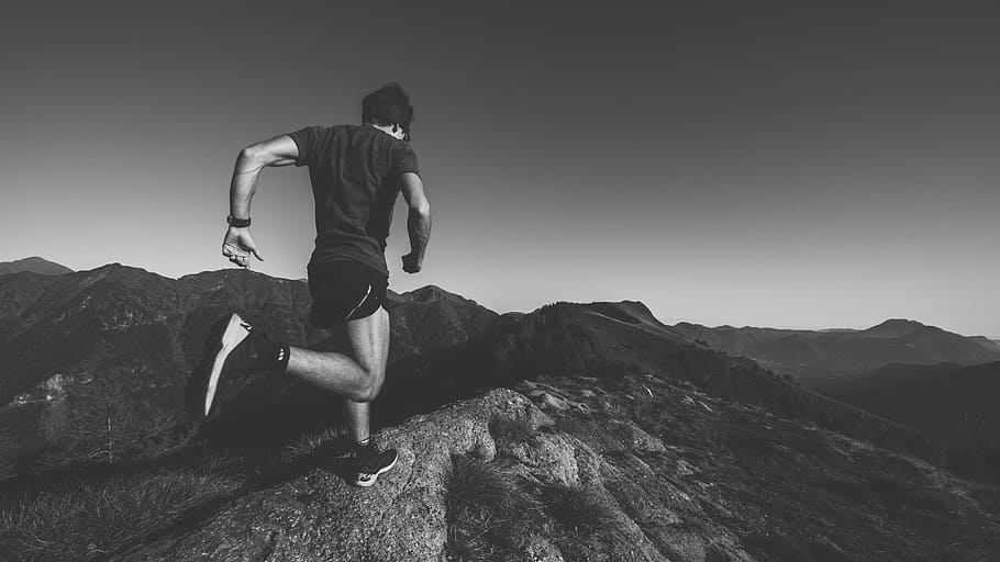 greyscale photography of man running on the field, mountain HD wallpaper