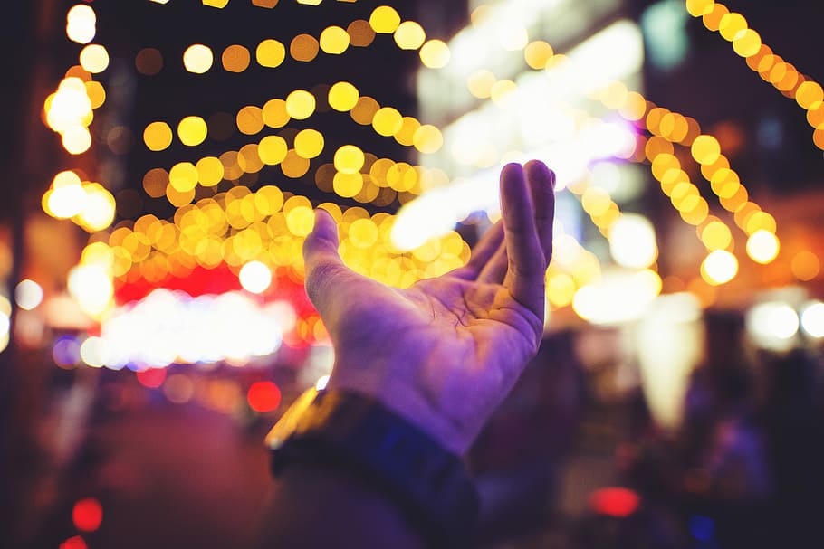 selective focus photography of person's left hand with yellow bokeh light background, bokeh photograph of person's left hand HD wallpaper