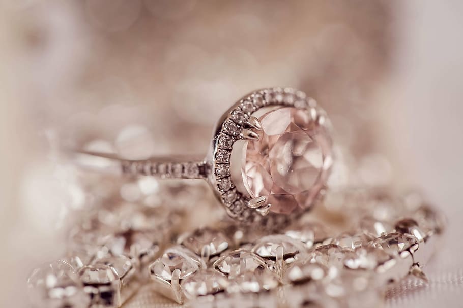 selective focus photography of silver-colored pink gemstone ring