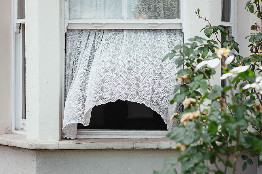 white sash window opened, closeup photo of white lace window curtain
