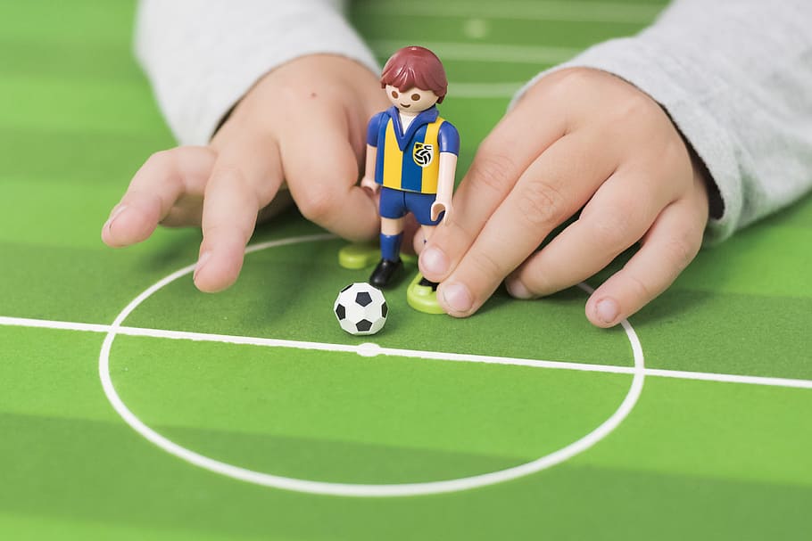 person playing minifig soccer, toddler holding soccer player figure HD wallpaper