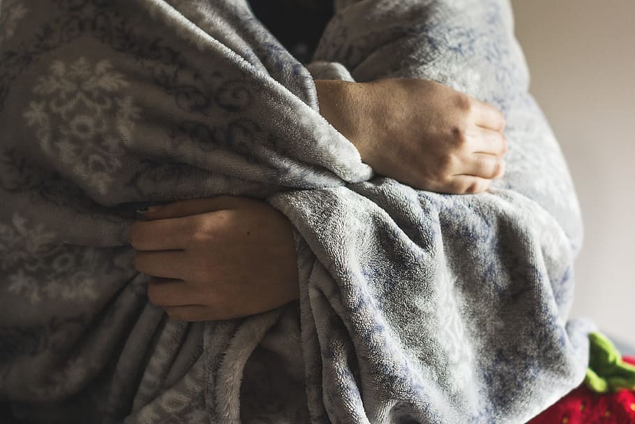 person wrapped in gray fleece blanket, cold, frost, winter, the disease