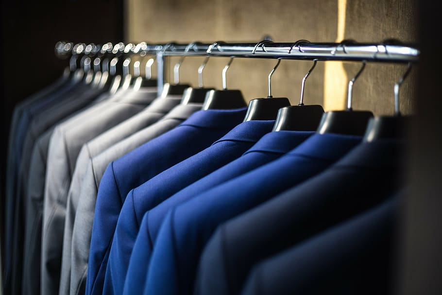 selective focus photography of suit jacket on hangers, fashion