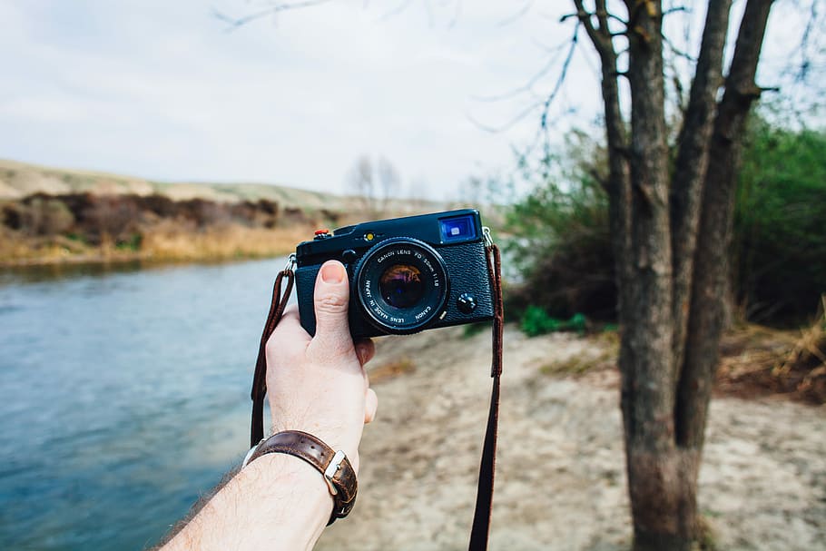 Rangefinder Love, person holding black camera near river, hand HD wallpaper