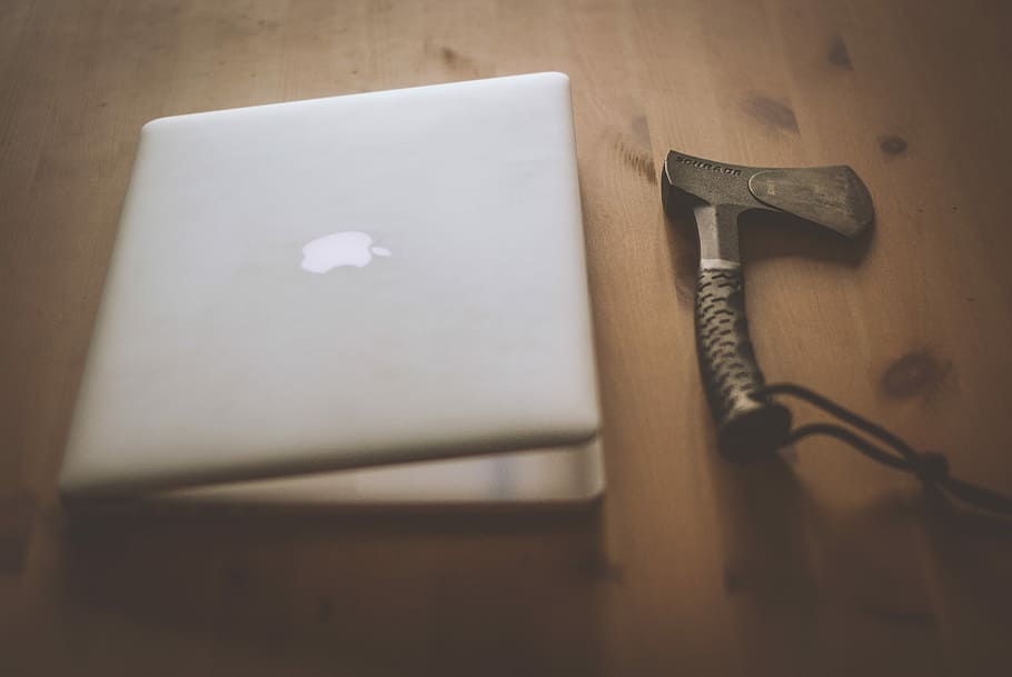 silver MacBook and black handheld tool, closed MacBook beside axe HD wallpaper