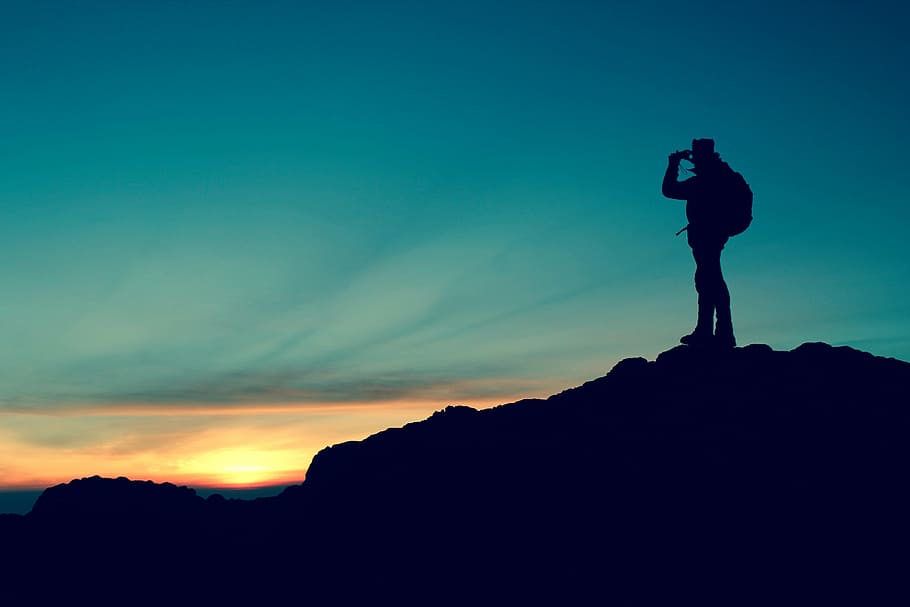 silhouette on man with backpack on mountain peak during golden house, HD wallpaper