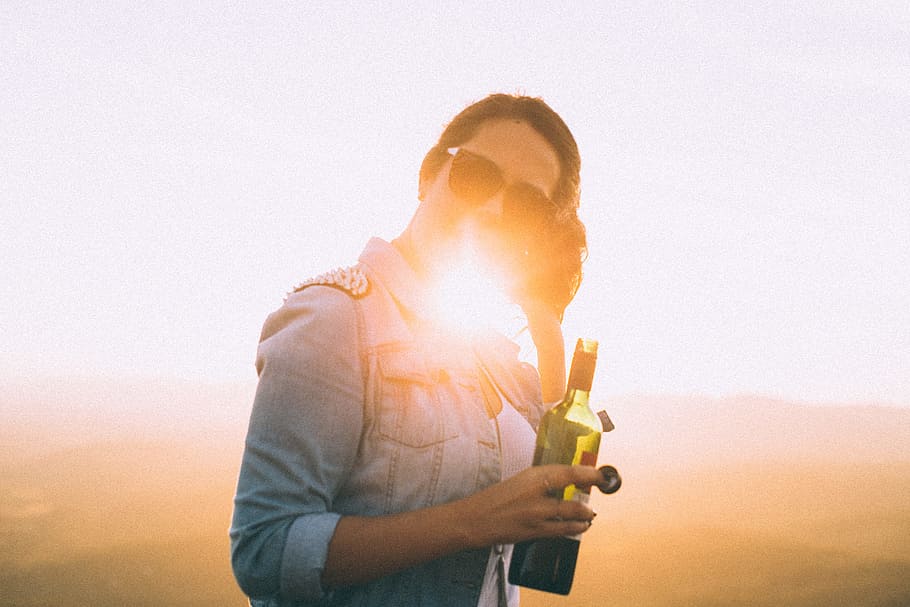 Woman Wearing Blue Denim Jacket Holding Wine Bottle in Golden Hour Photo, HD wallpaper