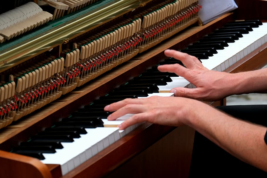 person plays upright piano, playing the piano, musician, instrument