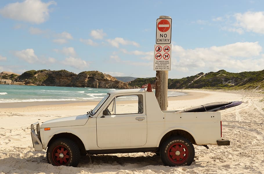 white single cab pickup truck parked beside brown pole with signboards HD wallpaper