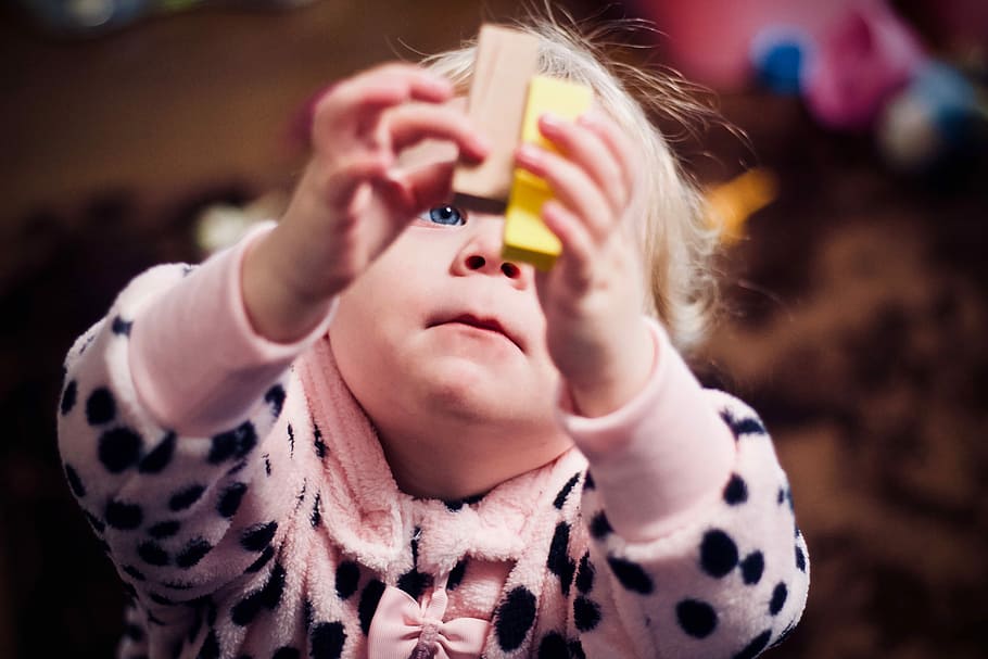 toddler playing with two wooden blocks, baby's holding brown and yellow brick toy, HD wallpaper