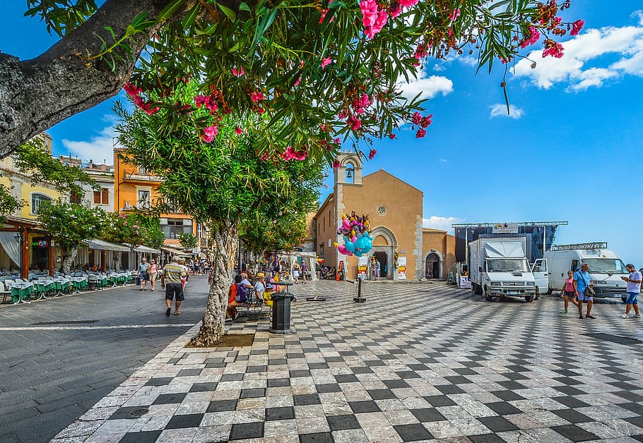 people walking on street, taormina, square, piazza, flowers, checkerboard