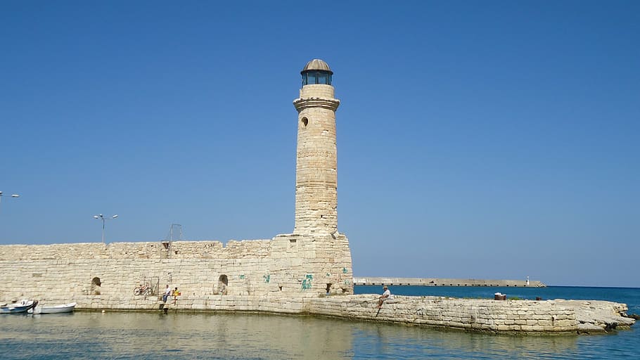 lighthouse under clear blue sky, harbour entrance, crete, rethymno
