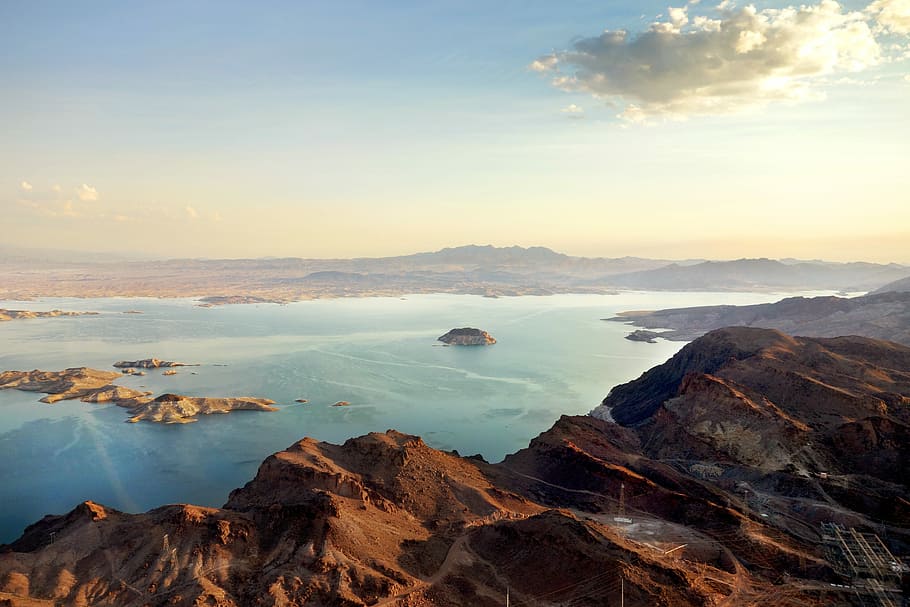 aerial view of body of water surrounded with mountains, brown mountain HD wallpaper