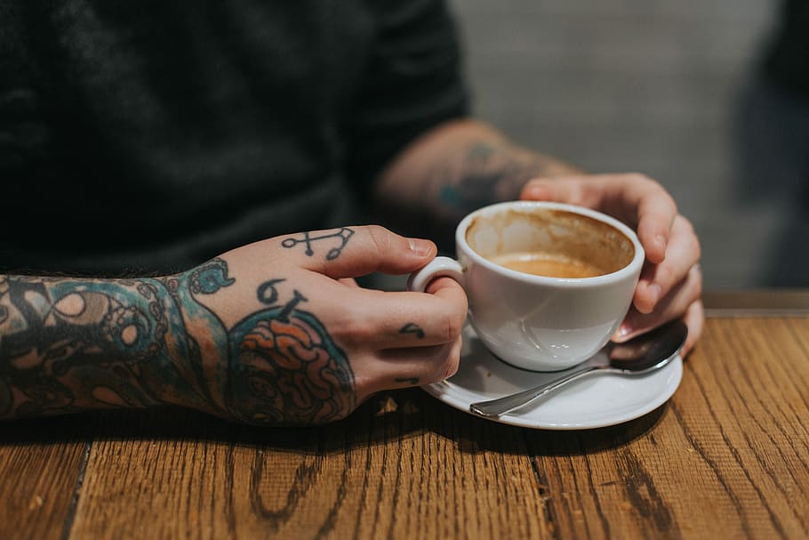 person holding white teacup on white saucer, person holding ceramic mug HD wallpaper