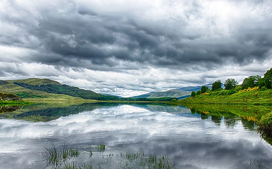 panoramic photography of mountain under gray and white clouds at daytime HD wallpaper