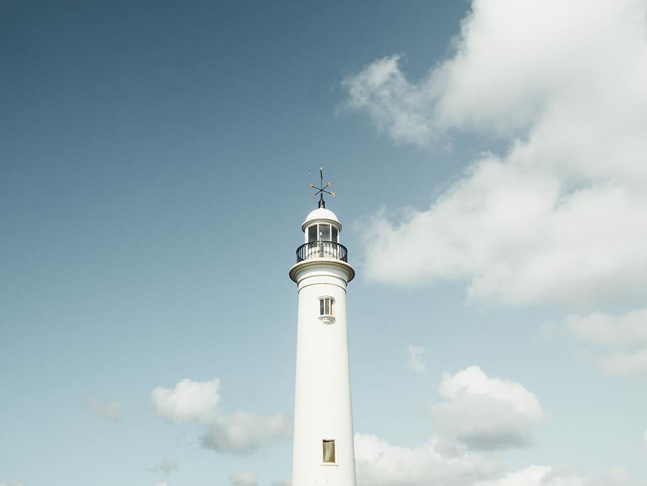 white lighthouse under white cumulus clouds, low angle photography of lighthouse HD wallpaper