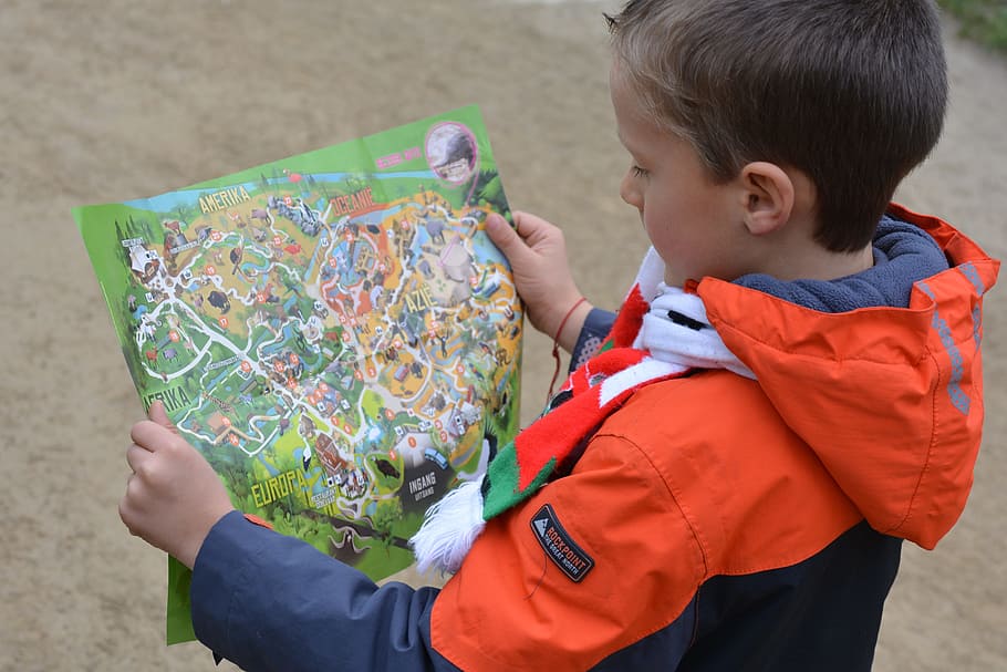 boy wearing orange and blue hoodie holding a green map, child HD wallpaper
