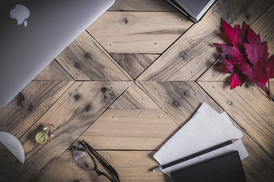 clear eyeglasses with black frames on brown parquet floor, eyeglasses, printer paper, and MacBook Pro on brown wooden surface HD wallpaper