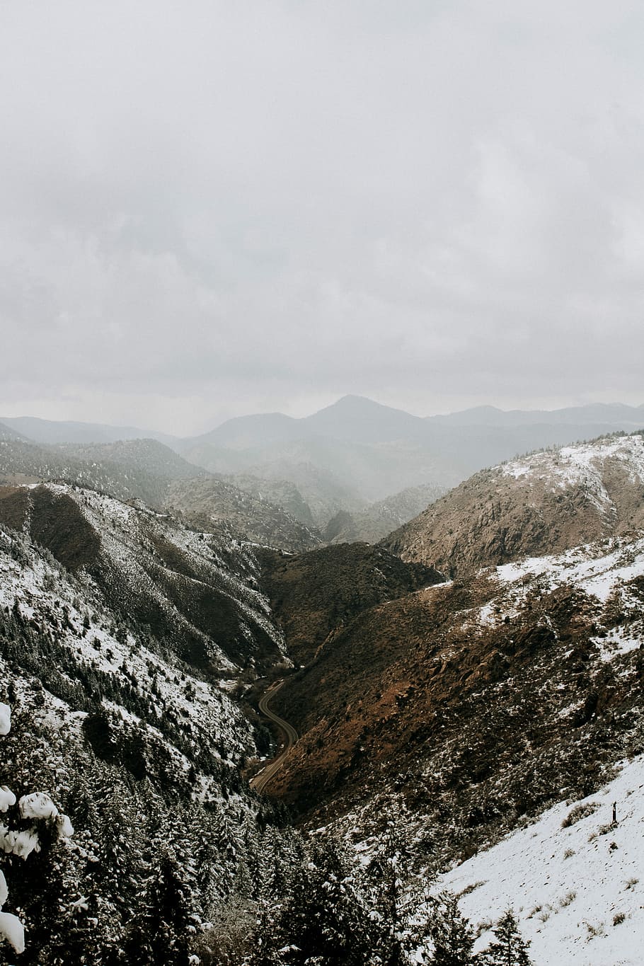 snow covered mountain under white clouds at daytime, aerial view photography of snowy mountain HD wallpaper