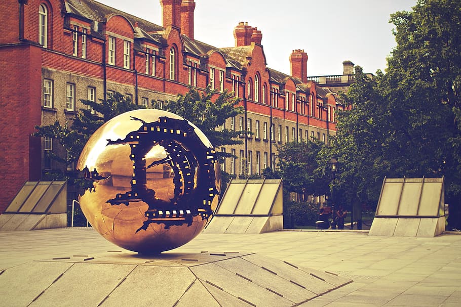 round gold monument near trees and concrete building, sphere HD wallpaper