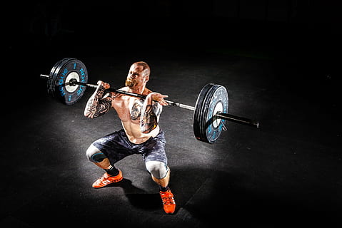 man wearing a black short while lifting a black steel barbell HD wallpaper