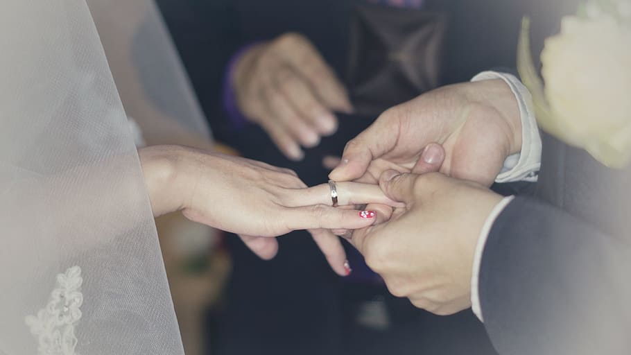 bride wearing wedding ring with groom, wedding rings, love, marriage