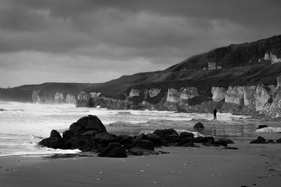 grayscale photo of sea shore with rocks, beach, north, coast