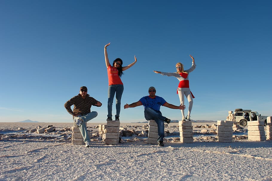 four people posing on pedestals in desert under clear day sky, HD wallpaper