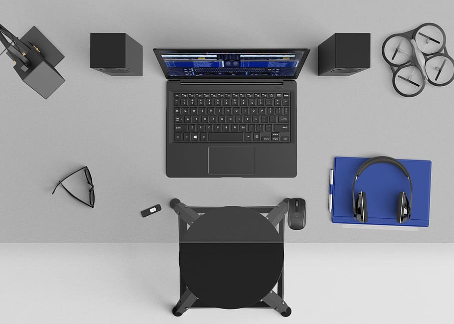 grey laptop computer with two speakers, black quadcopter drone, headset, and glasses on clear glass table HD wallpaper