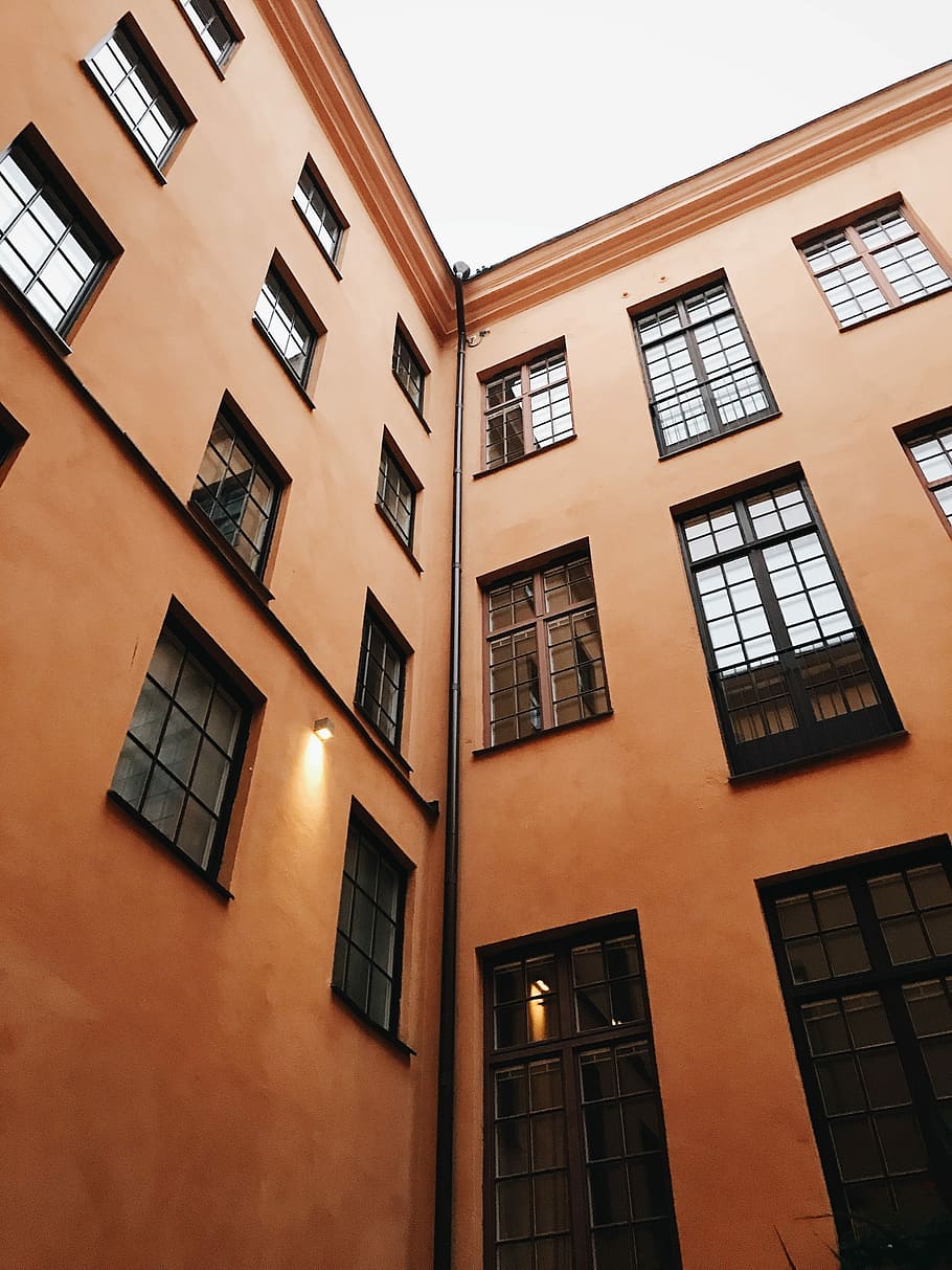 lowangle photography of orange concrete building, low angle photography of building HD wallpaper