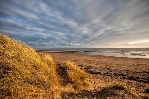 Landscape shot taken from the sand dunes at Camber Sands in East Sussex in the South of England HD wallpaper