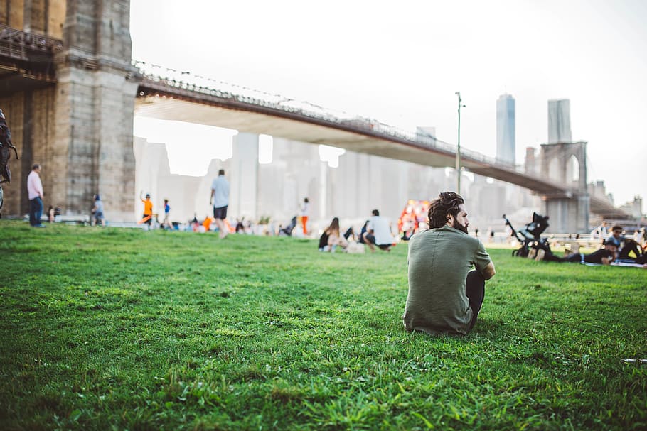 man sitting on grass near Brooklyn Bridge, guy, people, field HD wallpaper