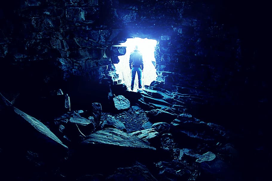 man outside cave, only, tunnel, light, solitude, rocks, real people HD wallpaper