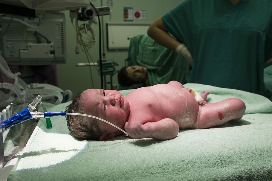 baby lying on green textile near hospital machine, Baby, Birth