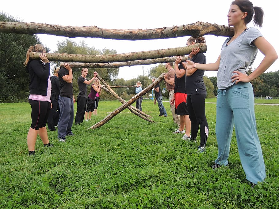 group of women carrying branches on their shoulders, group training HD wallpaper