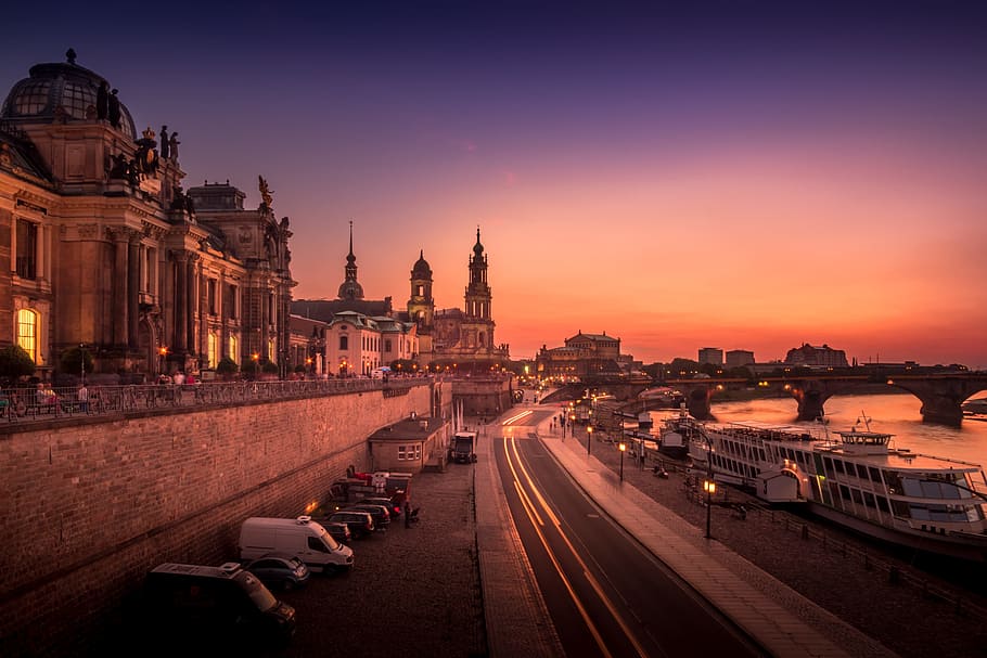 time-lapse photography of road near buildings and body of water with bridge HD wallpaper