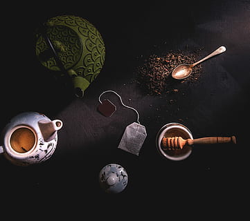 two teapots beside mortar and pestle, low-angle photography of teabag, kettle, spoon, and pestle HD wallpaper