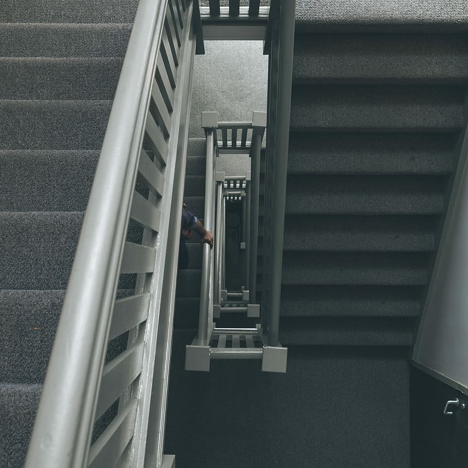 photo of grey staircase with grey metal railings, person holding white rail HD wallpaper