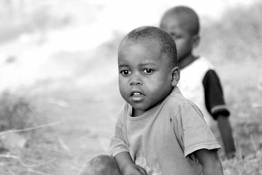 grayscale photography of two boy sitting on floor, africa children
