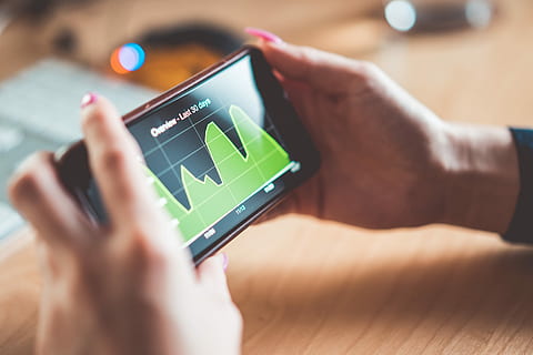 Young Woman Analyzing Website Traffic/Earnings Chart on iPhone HD wallpaper
