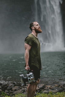 man looking up, man standing beside fall while holding gray component HD wallpaper