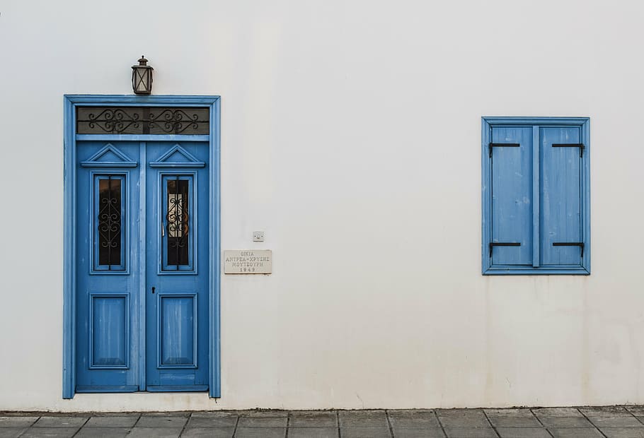white concrete wall with blue door and window, wooden, entrance