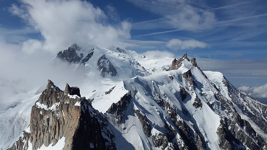 in distant photo of mountain peak, aiguille du midi, chamonix
